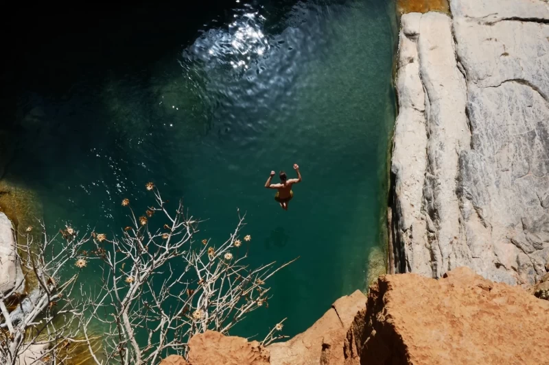 Guest jumping in the Valley Paradise near Tamraght, Morocco during a surf camp excursion