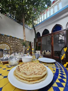 Freshly prepared Moroccan msemen on a table in the surf camp garden in Taghazout, Morocco. Traditional breakfast experience