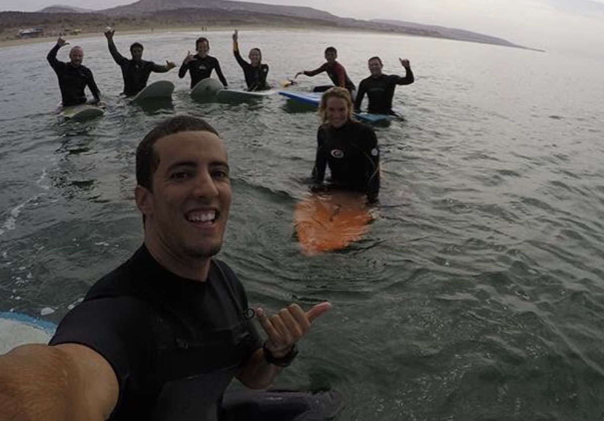 Group of guests enjoying their time on the beach in Taghazout, Morocco. Surf adventure and fun at Nomad Surf Camp