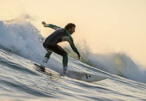 Surf instructor Jalal catching a big wave at Anchor Point, Taghazout, Morocco. Professional surfing action at Nomad Surf Camp