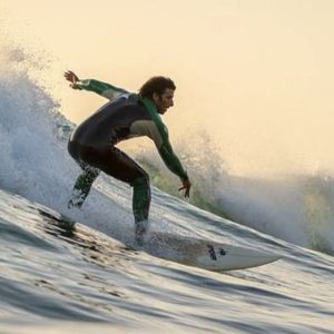 Surf instructor Jalal catching a big wave at Anchor Point, Taghazout, Morocco. Professional surfing action at Nomad Surf Camp