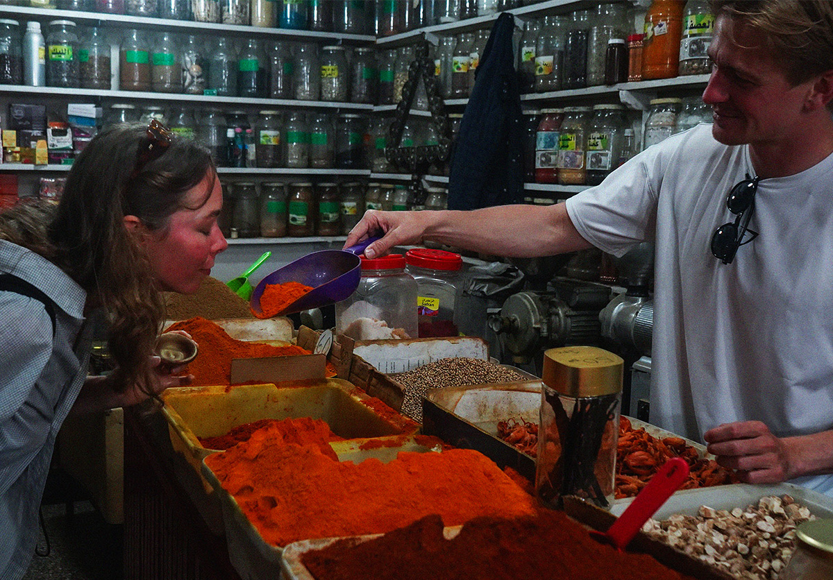 Two Nomad Surf Camp guests exploring Agadir souk, the largest market in Africa, and discovering Moroccan spices