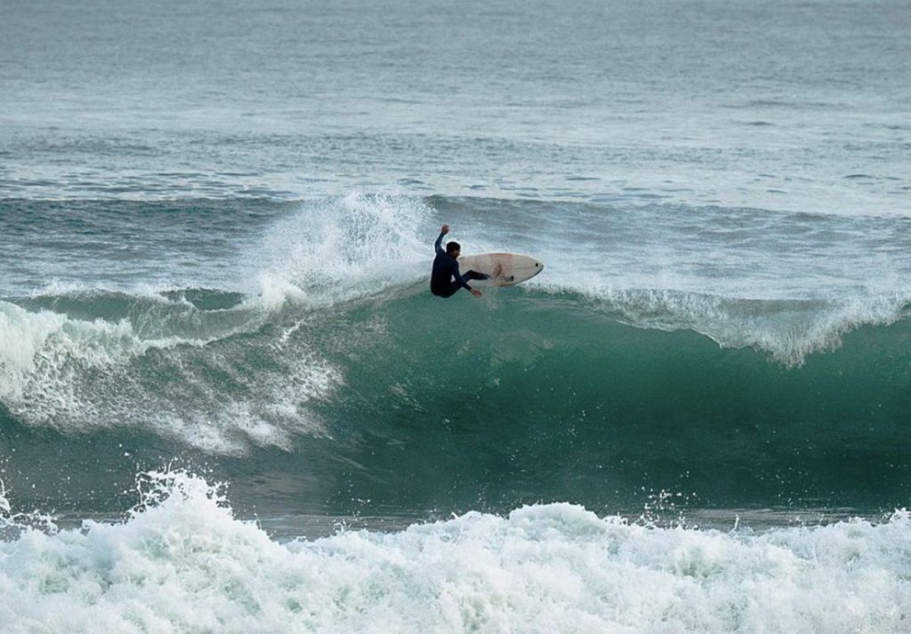 Surfer catching a wave in Taghazout, Morocco. Action-packed surfing experience on the Moroccan coast