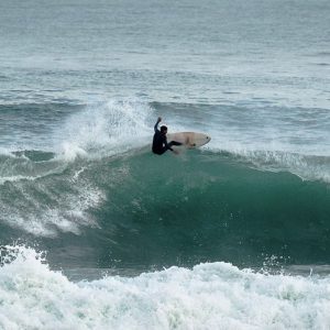 Surfer catching a wave in Taghazout, Morocco. Action-packed surfing experience on the Moroccan coast