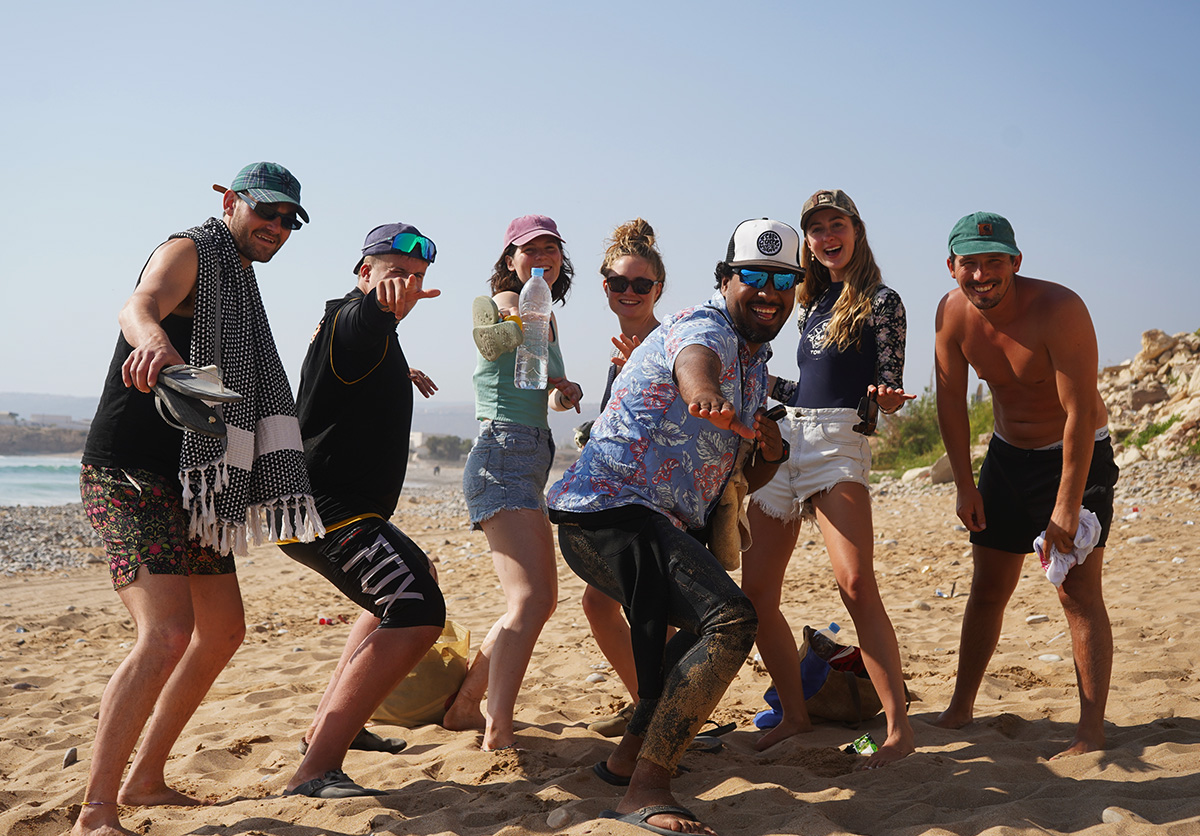 Group of guests posing for a photo in Taghazout, Morocco, after catching great waves. Surf adventure and celebration